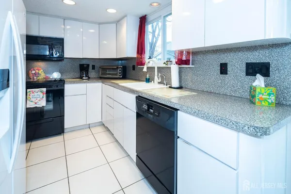 a kitchen with stainless steel appliances granite countertop a stove a refrigerator and a microwave