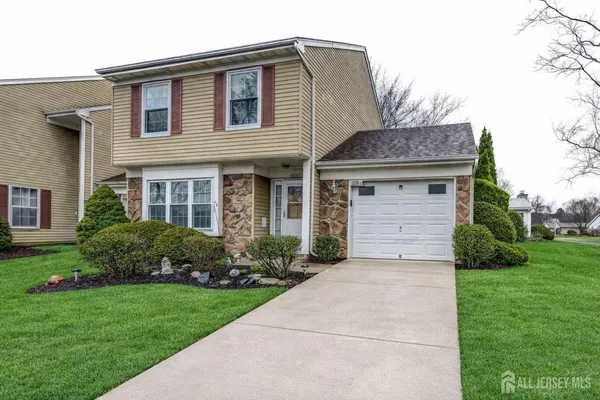 a front view of a house with a garden