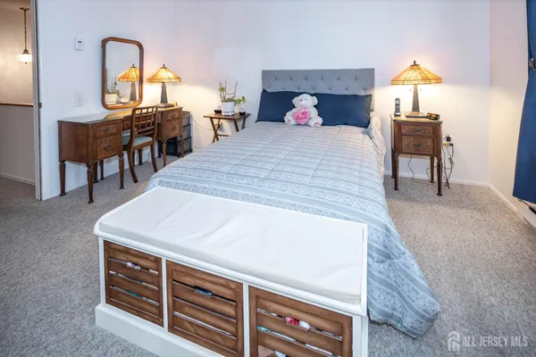 a bedroom with a bed and a television