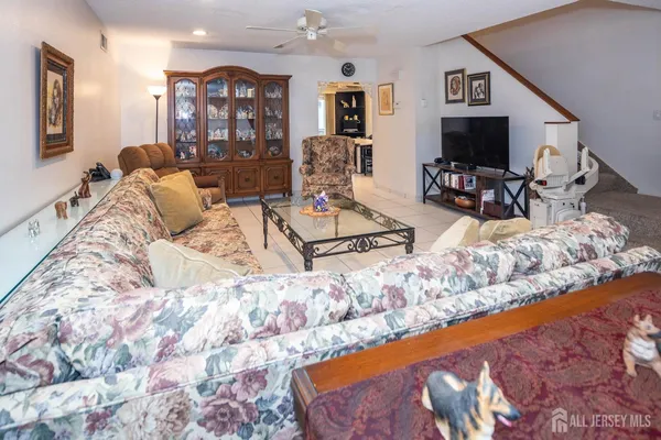 a living room with couches and a flat screen tv