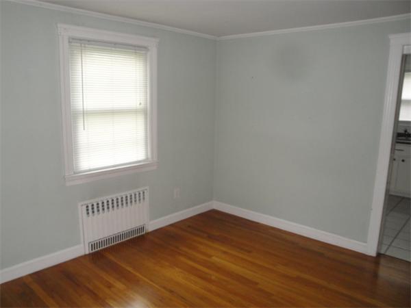 122 Bacon Road Barnstable, MA 02601 - Photo 3 of 18 a view of an empty room with wooden floor and a window