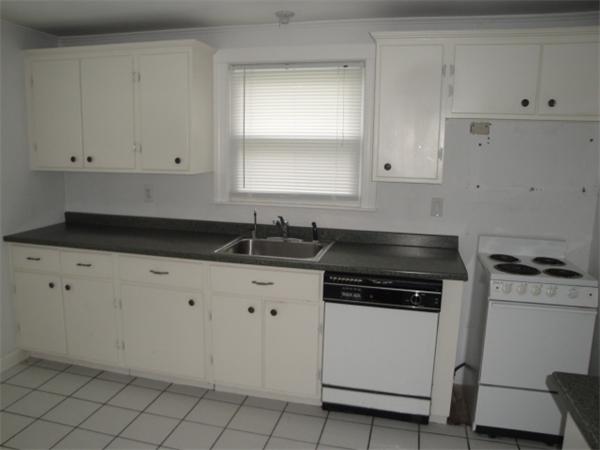 122 Bacon Road Barnstable, MA 02601 - Photo 4 of 18 a kitchen with granite countertop white cabinets and white appliances