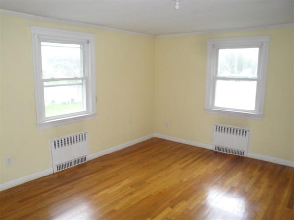 122 Bacon Road Barnstable, MA 02601 - Photo 10 of 18 a view of an empty room with wooden floor and a window