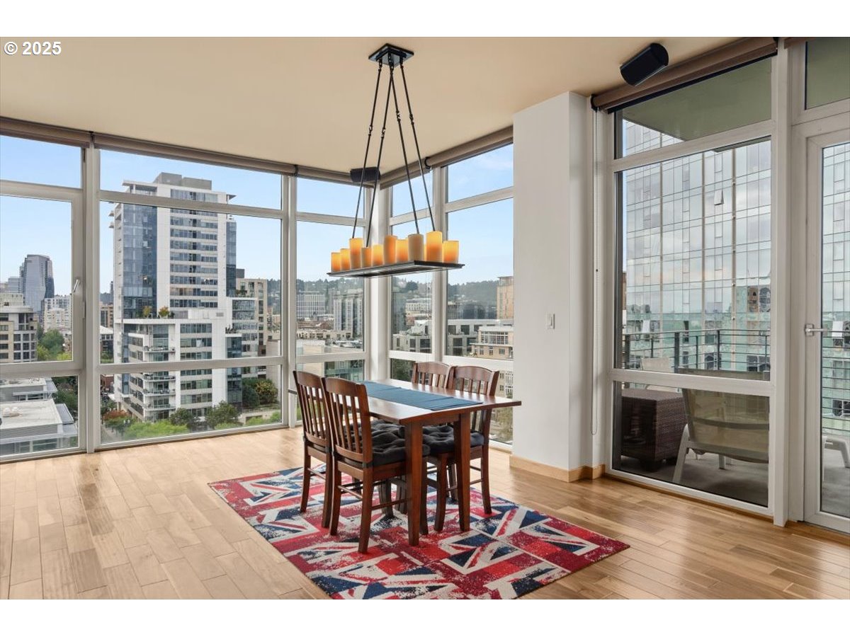 1255 Northwest 9th Avenue, Unit 910 Portland, OR 97209 - Photo 14 of 43 a dining room with furniture a chandelier and wooden floor