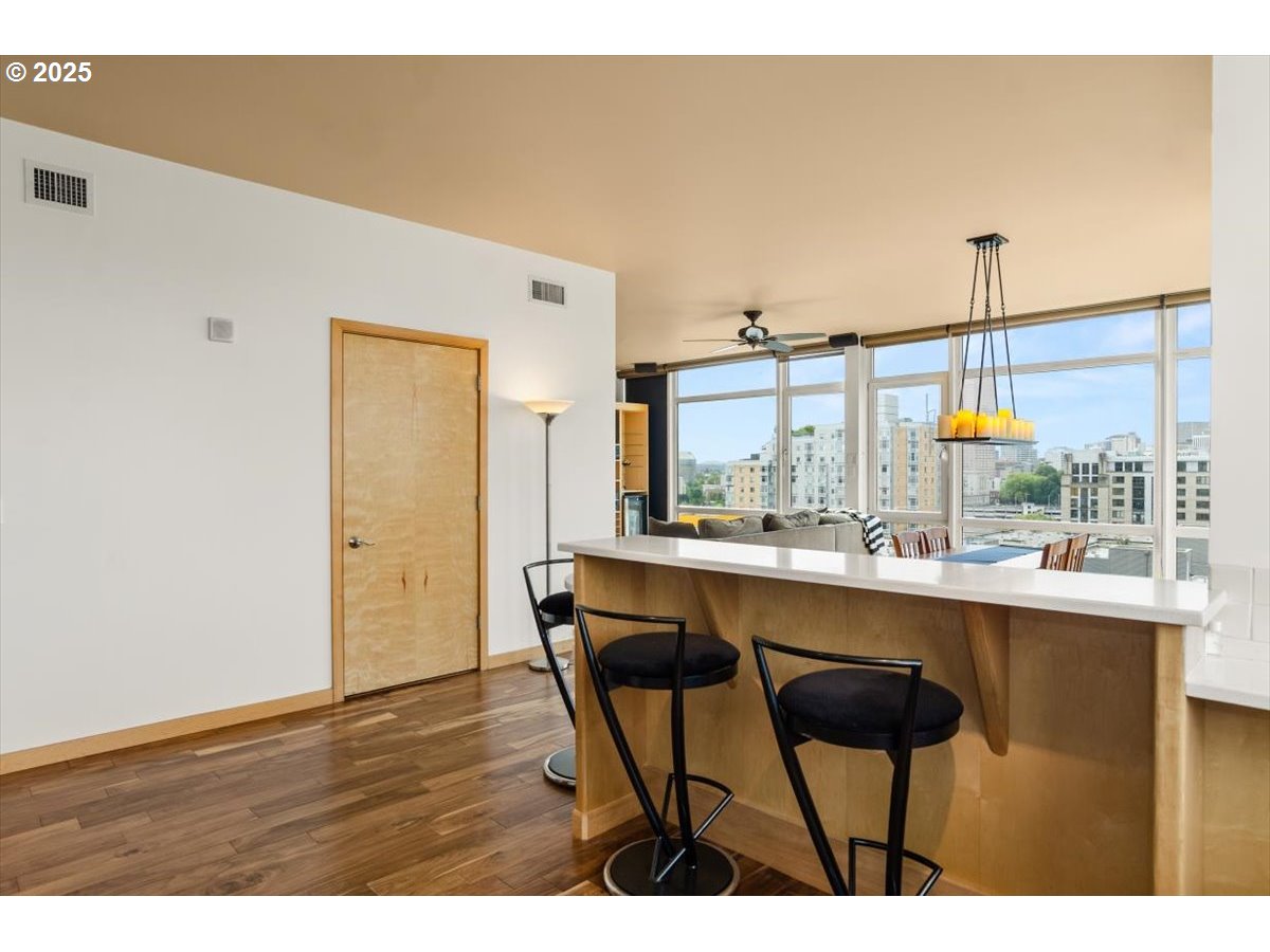 1255 Northwest 9th Avenue, Unit 910 Portland, OR 97209 - Photo 15 of 43 a kitchen with a sink cabinets and wooden floor