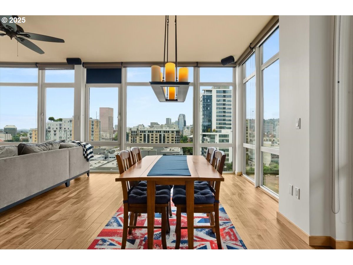 1255 Northwest 9th Avenue, Unit 910 Portland, OR 97209 - Photo 16 of 43 a dining room with furniture a chandelier and wooden floor