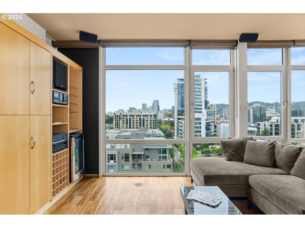 1255 Northwest 9th Avenue, Unit 910 Portland, OR 97209 - Photo 19 of 43 a living room with furniture a floor to ceiling window and wooden floor