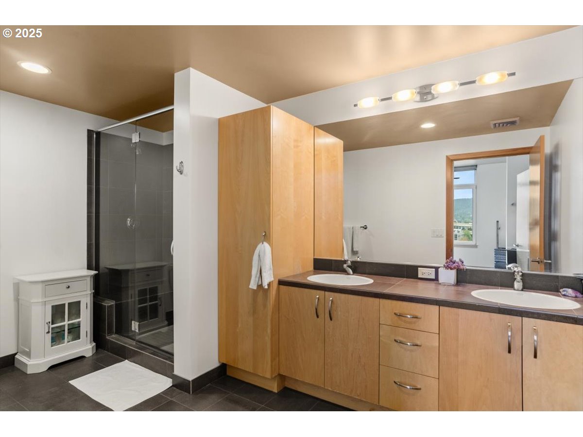 1255 Northwest 9th Avenue, Unit 910 Portland, OR 97209 - Photo 24 of 43 a bathroom with a double vanity sink and a mirror
