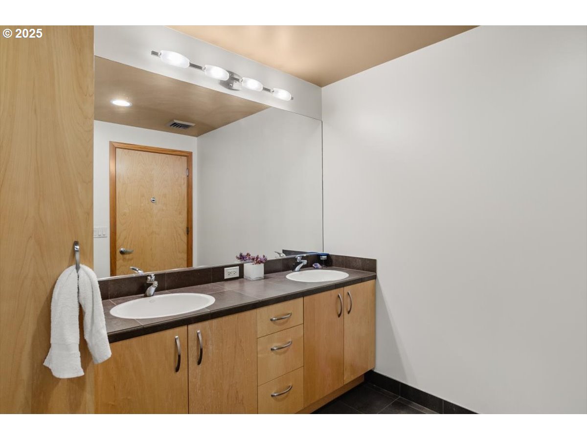 1255 Northwest 9th Avenue, Unit 910 Portland, OR 97209 - Photo 25 of 43 a bathroom with a sink and a mirror