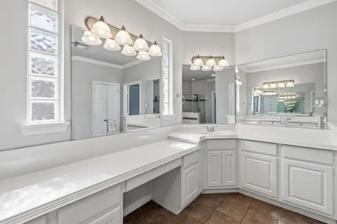 a bathroom with a sink vanity and mirror