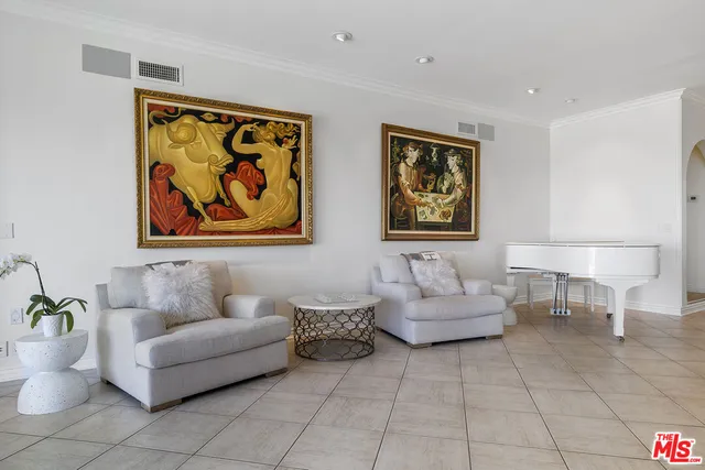 a living room with furniture and a painting