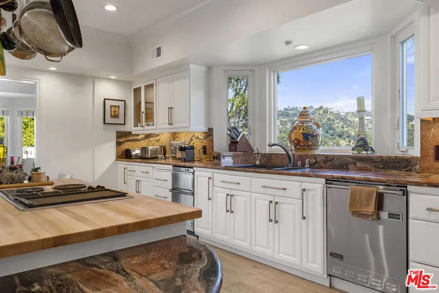 a spacious bedroom with a bed and a flat screen tv