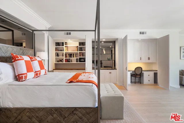 a view of a livingroom with workspace and a window