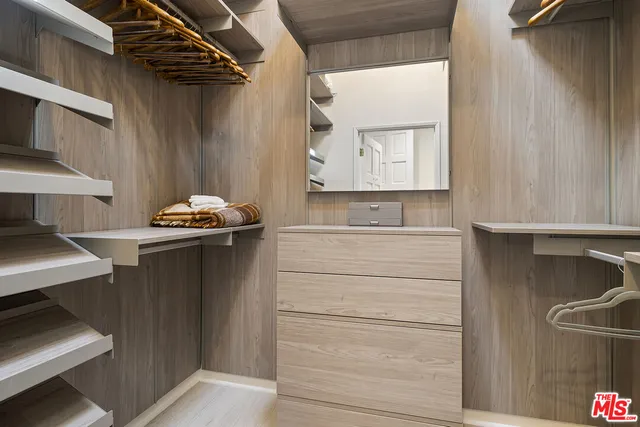 a bathroom with a sink a large mirror and a shower