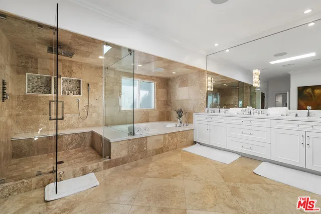 a bedroom with a large bed and a large window