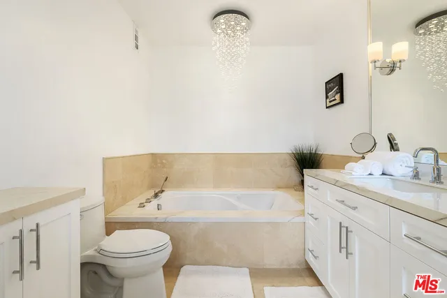 a bathroom with a granite countertop sink a shower and a mirror