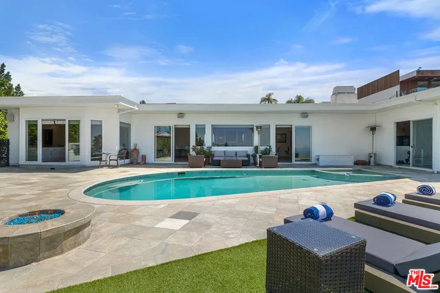 a view of a patio with table and chairs under an umbrella