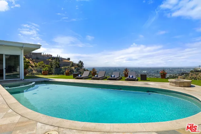 a front view of a house with outdoor seating