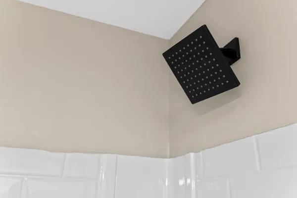 an empty room with wooden floor and ceiling fan