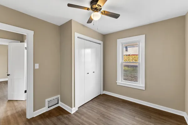 a view of a room with wooden floor