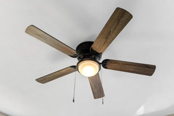 a view of a big room with wooden floor and windows