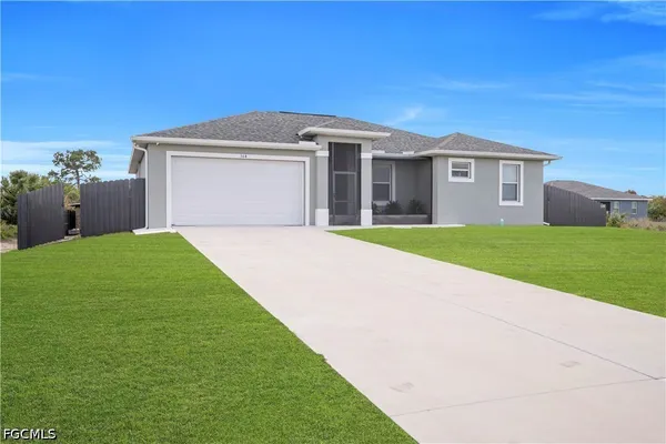 a front view of a house with a yard and garage