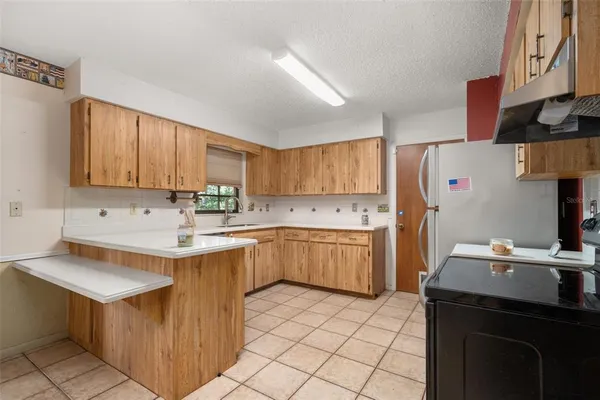 a kitchen with a sink cabinets and appliances