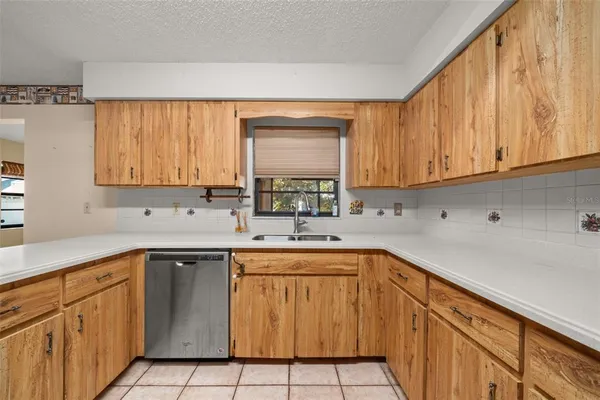 a kitchen with sink cabinets and window
