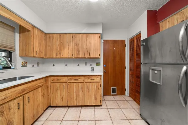 a kitchen with stainless steel appliances granite countertop a refrigerator and a sink