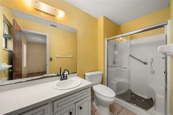 a bathroom with a sink toilet a mirror and shower