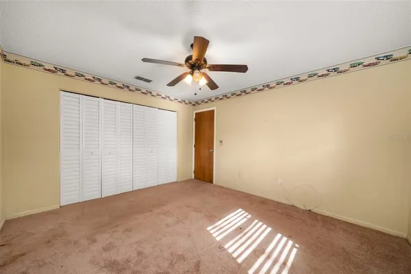 a very nice looking room with a ceiling fan