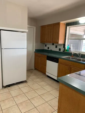 a kitchen with stainless steel appliances a refrigerator sink and cabinets