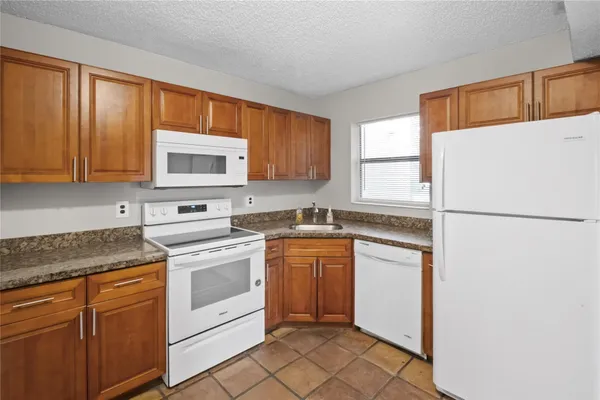a kitchen with a refrigerator stove and microwave