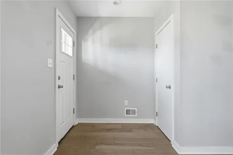 wooden floor in an empty room with a window