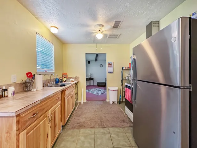 a kitchen with refrigerator a sink dishwasher and a refrigerator