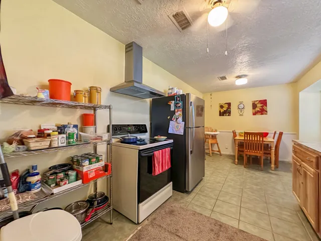 a kitchen with stainless steel appliances granite countertop a sink and a stove