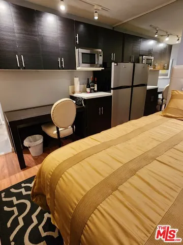 a bathroom with a sink and mirror with toilet