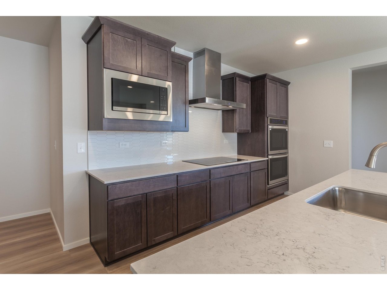 792 Chatter Road Windsor, CO 80550 - Photo 14 of 49 a kitchen with stainless steel appliances granite countertop a sink and a microwave