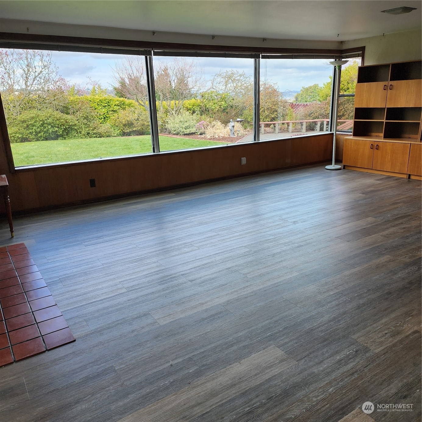 115 Monterey Place Northeast Renton, WA 98056 - Photo 20 of 35 a view of an empty room with wooden floor and a window