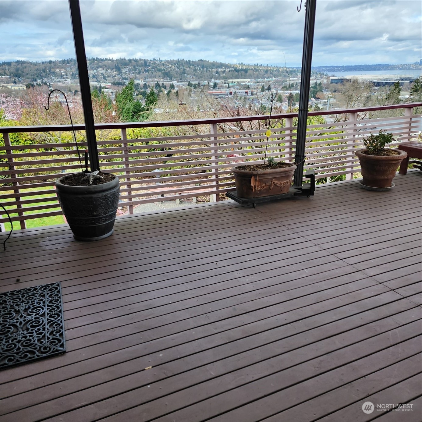 115 Monterey Place Northeast Renton, WA 98056 - Photo 5 of 35 a view of a balcony with floor to ceiling windows with wooden floor