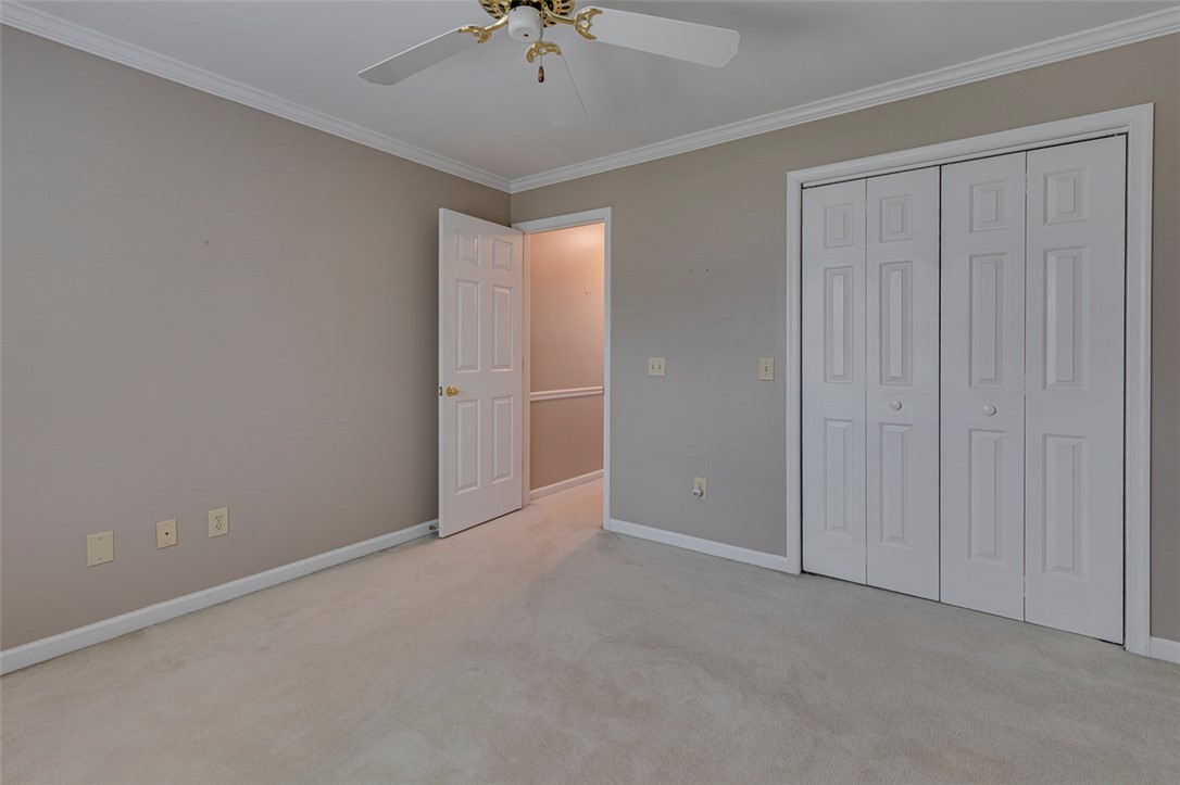 302 Wild Rice Drive Simpsonville, SC 29681 - Photo 34 of 44 Plush carpeting and classic crown molding define this versatile bedroom with double closet doors.