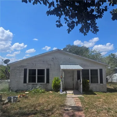 a front view of a house with garden and porch