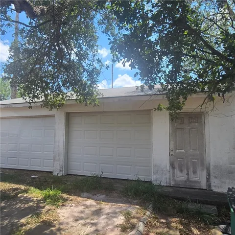 a house view with a tree in front of it