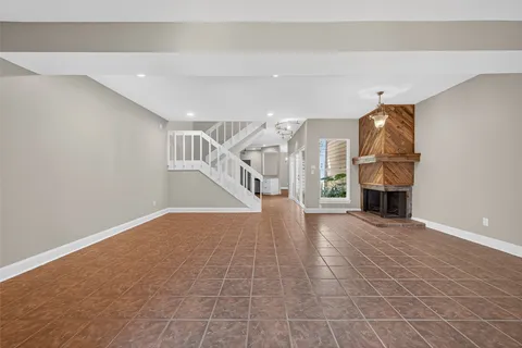 a view of empty room with fireplace and window