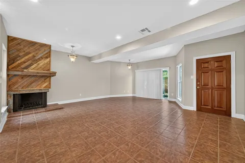 a view of an empty room with a fireplace