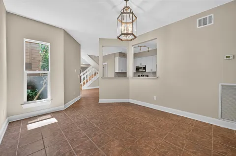 a view of an entryway with wooden floor and a chandelier