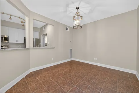 a view of a kitchen with a dishwasher and a white cabinets