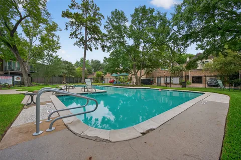 a view of a house with a backyard porch and sitting area