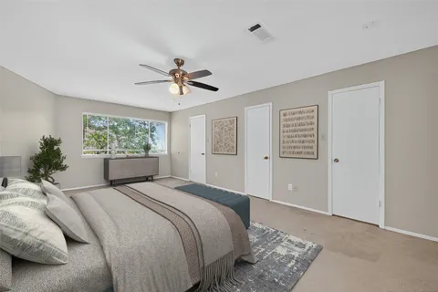 a bedroom with a large bed and a window