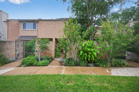 a view of green field with house in the background